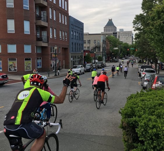 People riding a bike during Sales Factory's bike to work week
