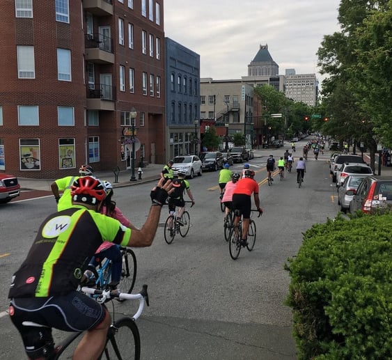 People riding a bike during Sales Factory's bike to work week